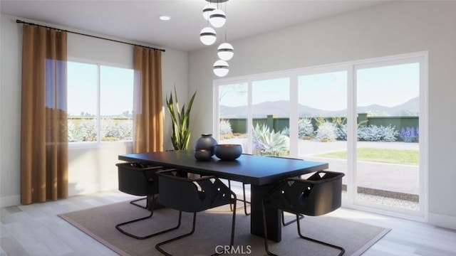 office featuring baseboards, light wood-style floors, and a mountain view