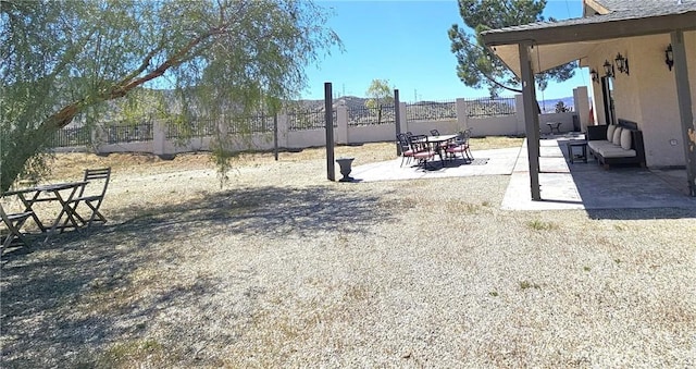 view of yard featuring fence and a patio