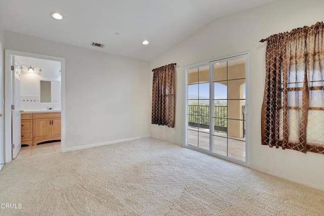 interior space featuring recessed lighting, vaulted ceiling, light carpet, baseboards, and visible vents