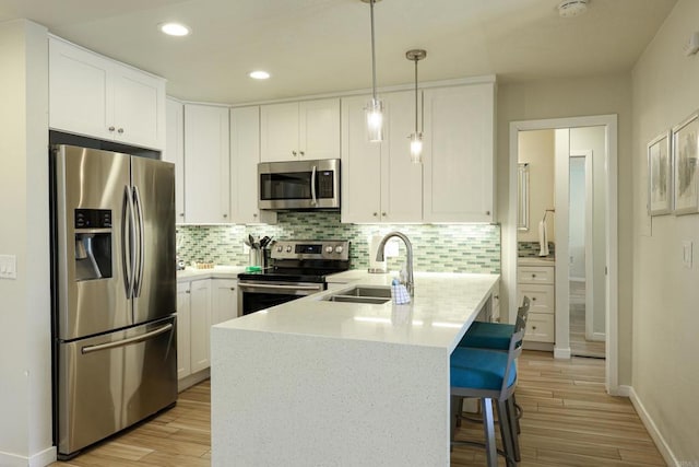 999 N Pacific St Unit E108, Oceanside, CA 92054 - kitchen with appliances with stainless steel finishes, a sink, light wood-style floors, and baseboards