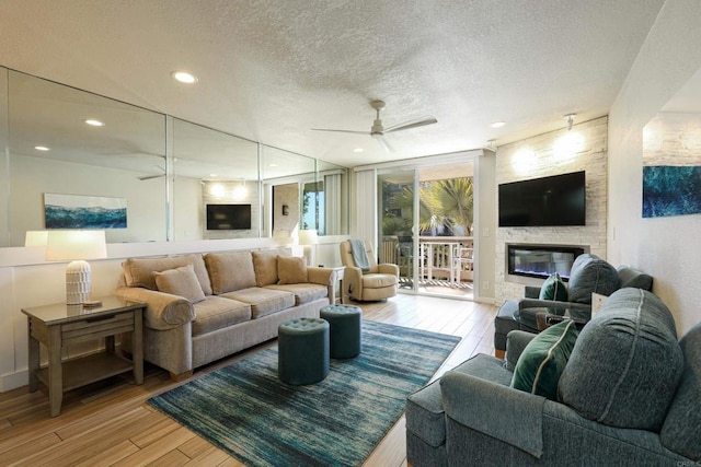 999 N Pacific St Unit E108, Oceanside, CA 92054 - living room featuring recessed lighting, a fireplace, ceiling fan, a textured ceiling, and wood finished floors