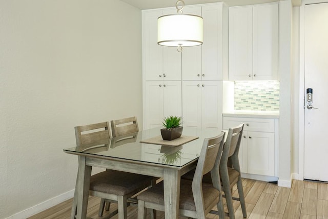 999 N Pacific St Unit E108, Oceanside, CA 92054 - dining space featuring light wood-style floors and baseboards