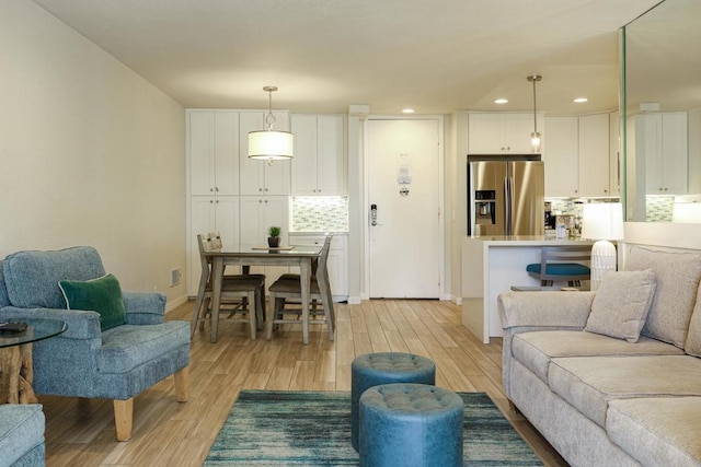 999 N Pacific St Unit E108, Oceanside, CA 92054 - living area with recessed lighting, light wood finished floors, and baseboards