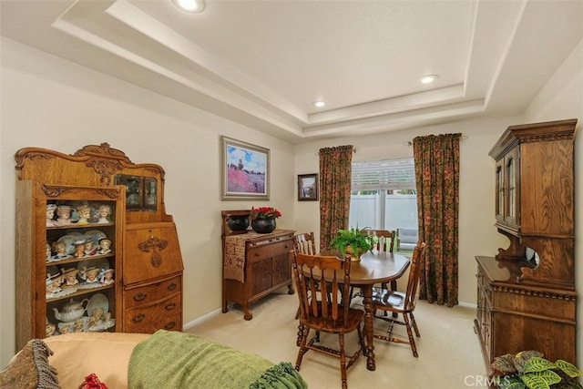 dining area featuring baseboards, recessed lighting, light carpet, and a tray ceiling