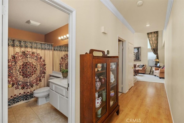 bathroom featuring toilet, a shower with curtain, ornamental molding, and vanity