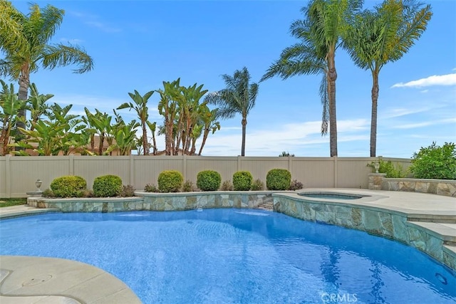 view of swimming pool with a fenced backyard, an in ground hot tub, and a fenced in pool