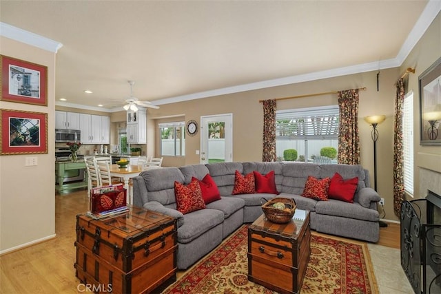 living room featuring baseboards, recessed lighting, ornamental molding, and ceiling fan