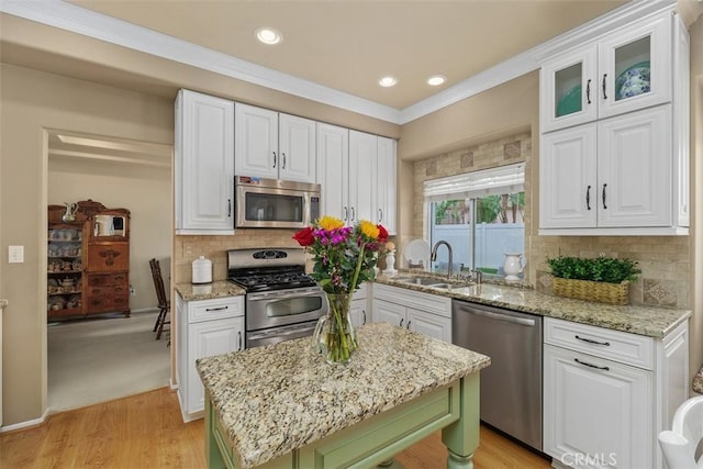 kitchen featuring a sink, white cabinets, and appliances with stainless steel finishes