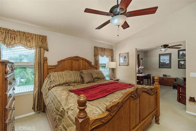 bedroom with baseboards, ceiling fan, light colored carpet, and vaulted ceiling