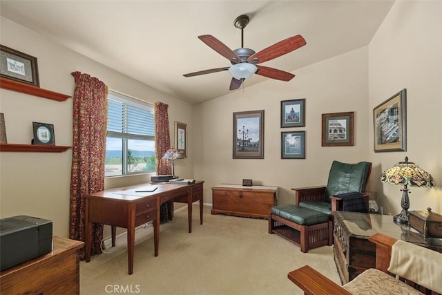 office featuring a ceiling fan, vaulted ceiling, light carpet, and baseboards
