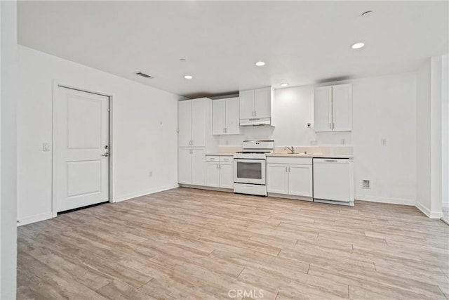 kitchen with white cabinetry, visible vents, under cabinet range hood, light wood-type flooring, and white appliances