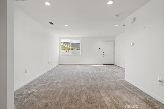 carpeted empty room featuring visible vents, recessed lighting, and baseboards