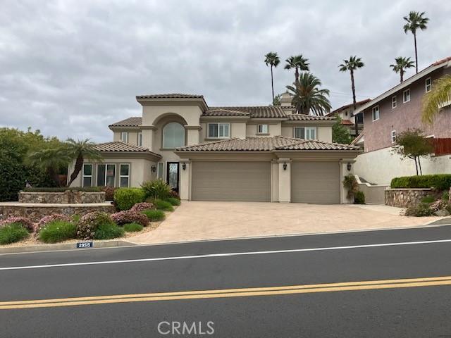 29515 Longhorn Dr, Canyon Lake, CA 92587 - mediterranean / spanish house with a garage, stucco siding, concrete driveway, and a tiled roof
