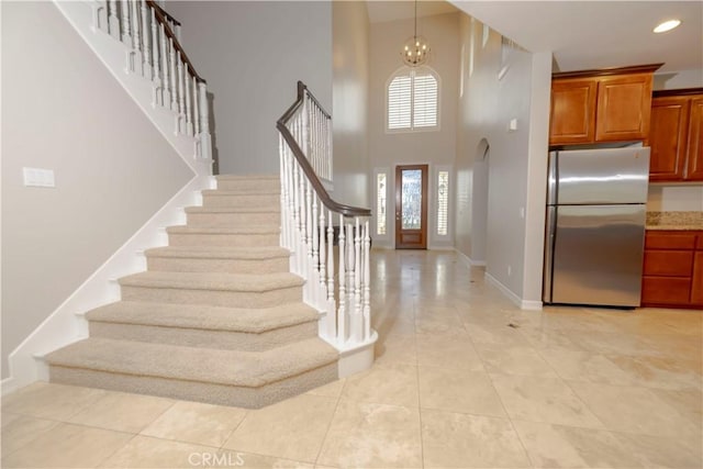 29515 Longhorn Dr, Canyon Lake, CA 92587 - entryway with stairs, baseboards, a high ceiling, a chandelier, and light tile patterned flooring