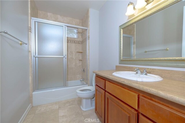 29515 Longhorn Dr, Canyon Lake, CA 92587 - bathroom featuring vanity, toilet, bath / shower combo with glass door, and tile patterned floors