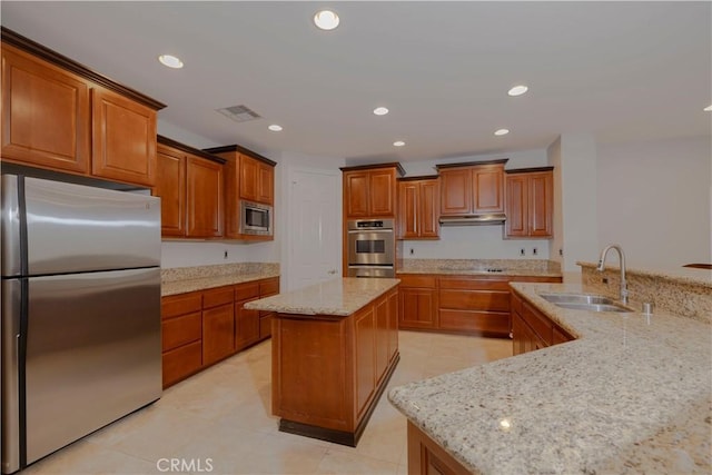 29515 Longhorn Dr, Canyon Lake, CA 92587 - kitchen featuring stainless steel appliances, a kitchen island, a sink, brown cabinets, and under cabinet range hood