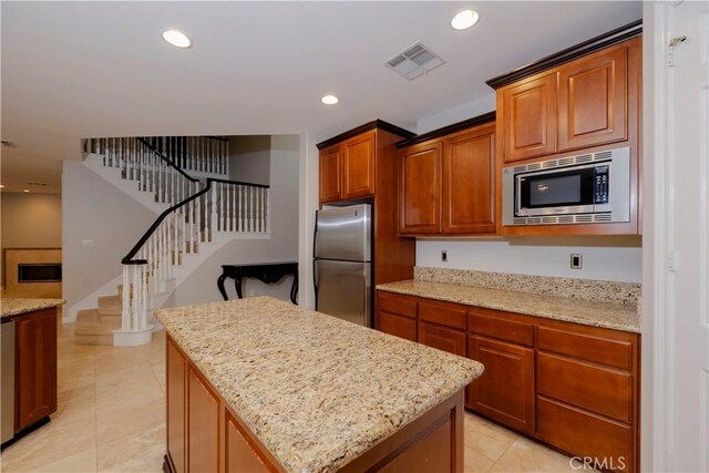 29515 Longhorn Dr, Canyon Lake, CA 92587 - kitchen with appliances with stainless steel finishes, a center island, recessed lighting, light stone countertops, and light tile patterned flooring