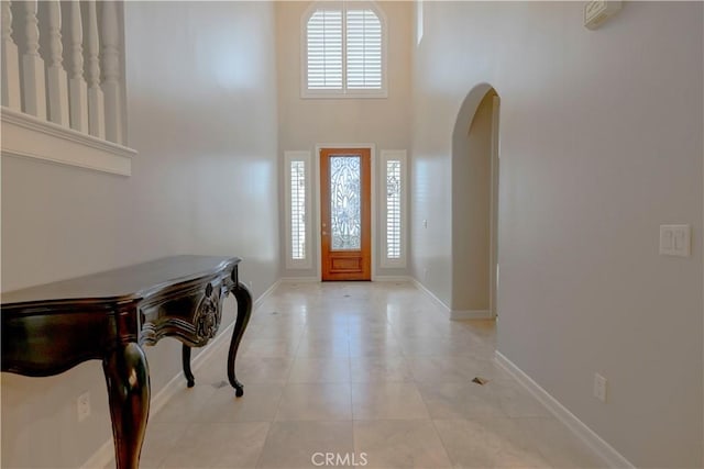 29515 Longhorn Dr, Canyon Lake, CA 92587 - entryway with baseboards, arched walkways, light tile patterned floors, and a high ceiling