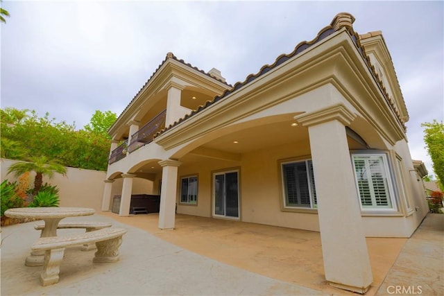 29515 Longhorn Dr, Canyon Lake, CA 92587 - back of house featuring a patio, a balcony, stucco siding, fence, and a tiled roof