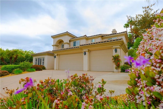 29515 Longhorn Dr, Canyon Lake, CA 92587 - mediterranean / spanish home featuring driveway, stucco siding, a tiled roof, and an attached garage