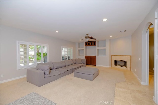 29515 Longhorn Dr, Canyon Lake, CA 92587 - living room with arched walkways, ceiling fan, recessed lighting, a fireplace with flush hearth, and light colored carpet