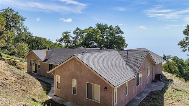 exterior space featuring central AC unit and stucco siding