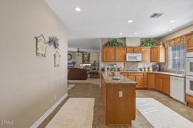 kitchen with a ceiling fan, recessed lighting, white appliances, visible vents, and a sink