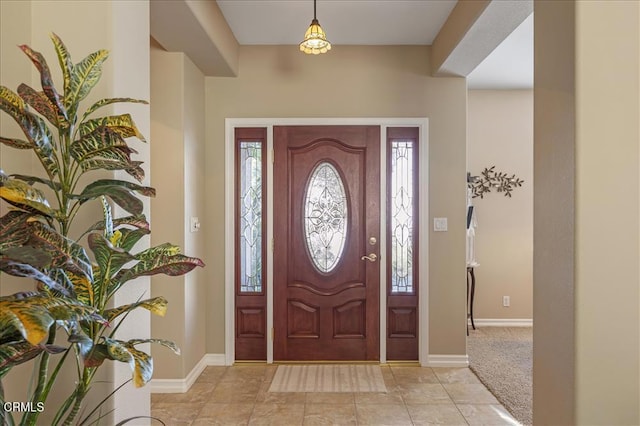 foyer entrance featuring baseboards