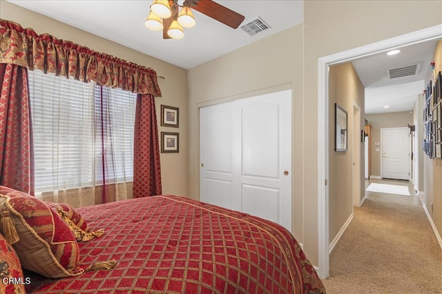 bedroom with carpet flooring, baseboards, a closet, and visible vents