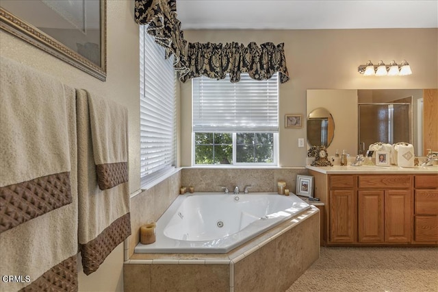 bathroom with a stall shower, double vanity, a whirlpool tub, and a sink