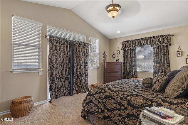 carpeted bedroom featuring baseboards, multiple windows, and vaulted ceiling