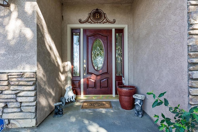 property entrance with stucco siding