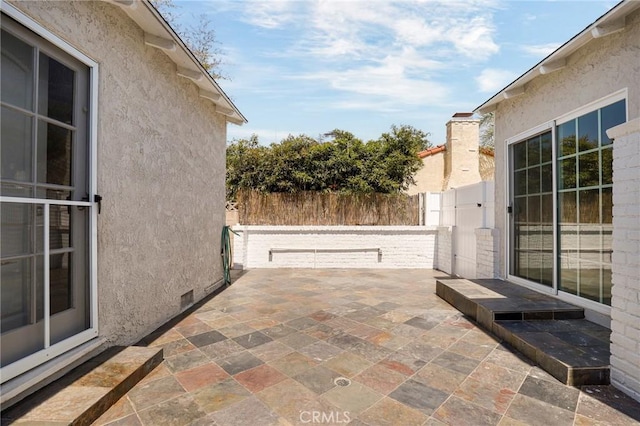 view of patio / terrace featuring fence