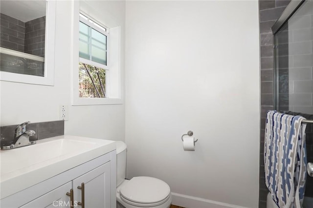 bathroom with walk in shower, toilet, and vanity