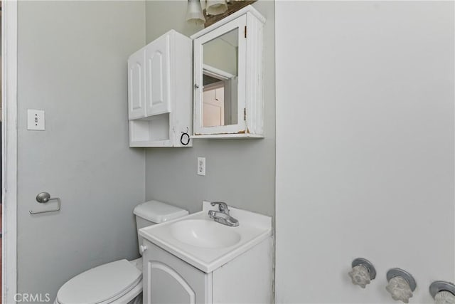 bathroom with toilet and vanity