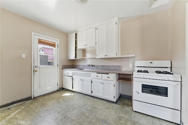 kitchen featuring open shelves, a sink, white cabinets, and white gas range oven