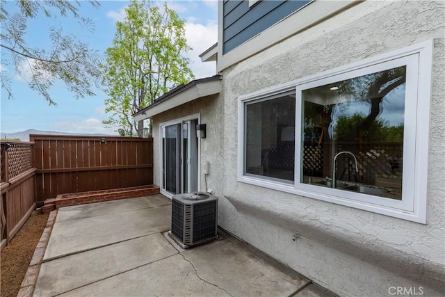 983 Elsa Ct Unit D, Corona, CA 92881 - view of patio with a fenced backyard and central air condition unit