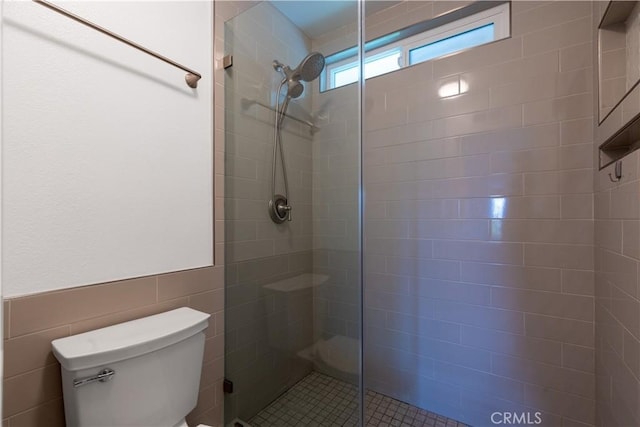 983 Elsa Ct Unit D, Corona, CA 92881 - full bath with toilet, tile walls, a wainscoted wall, and a stall shower