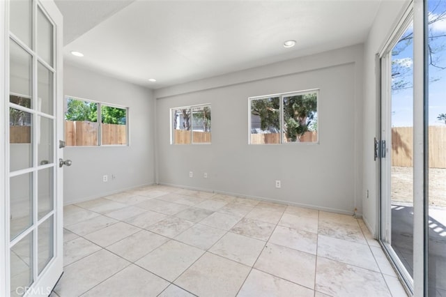 empty room featuring light tile patterned floors, french doors, recessed lighting, and baseboards