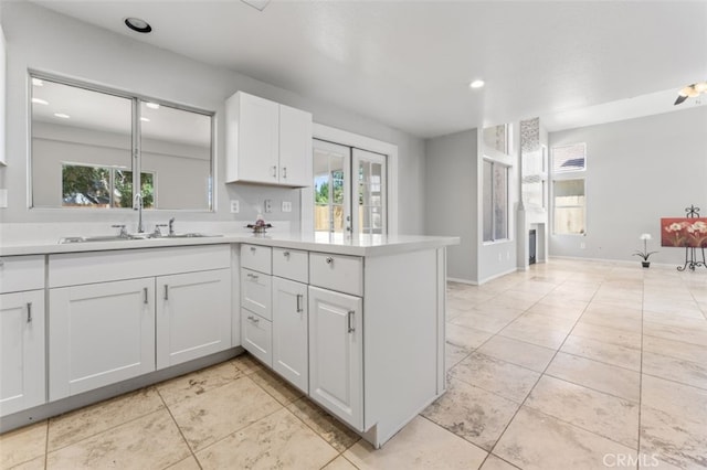 kitchen featuring light countertops, plenty of natural light, and a sink