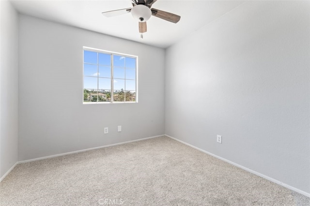 empty room with baseboards, ceiling fan, and carpet flooring