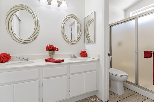 bathroom with a stall shower, tile patterned flooring, double vanity, and a sink