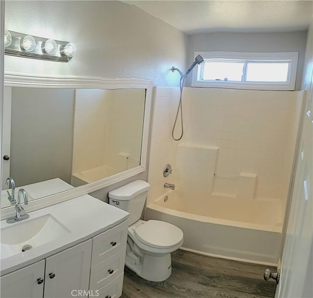 full bath with vanity, shower / bathtub combination, wood finished floors, and toilet