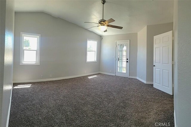 carpeted spare room with a ceiling fan, baseboards, a healthy amount of sunlight, and lofted ceiling