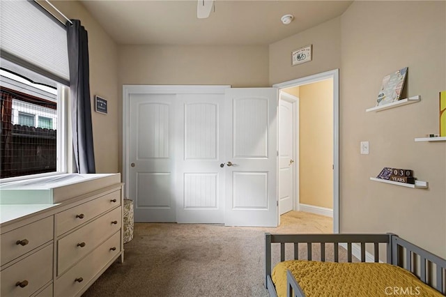 bedroom with a closet and light colored carpet