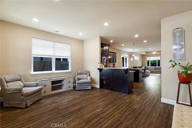living area featuring recessed lighting, baseboards, visible vents, and dark wood finished floors