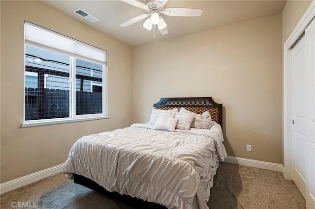 carpeted bedroom with baseboards, visible vents, ceiling fan, and a closet