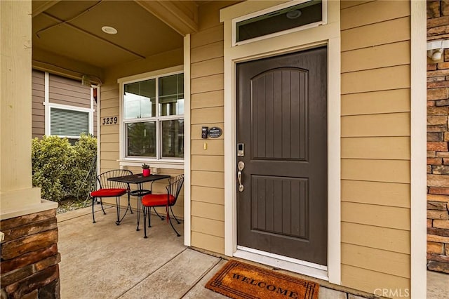 doorway to property featuring covered porch