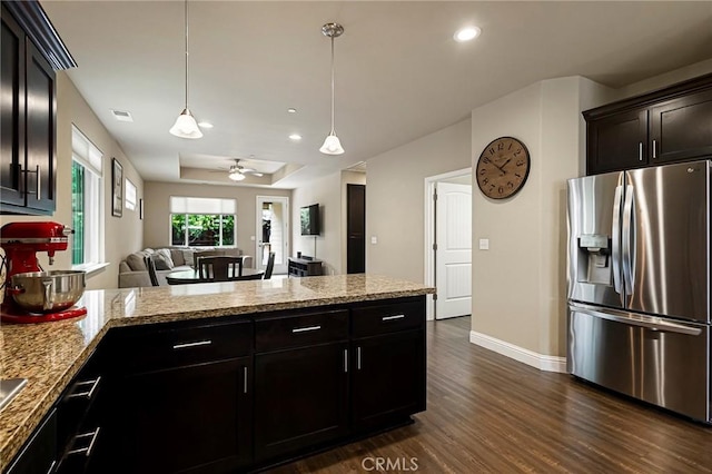 kitchen with dark wood-style flooring, a peninsula, baseboards, open floor plan, and stainless steel refrigerator with ice dispenser