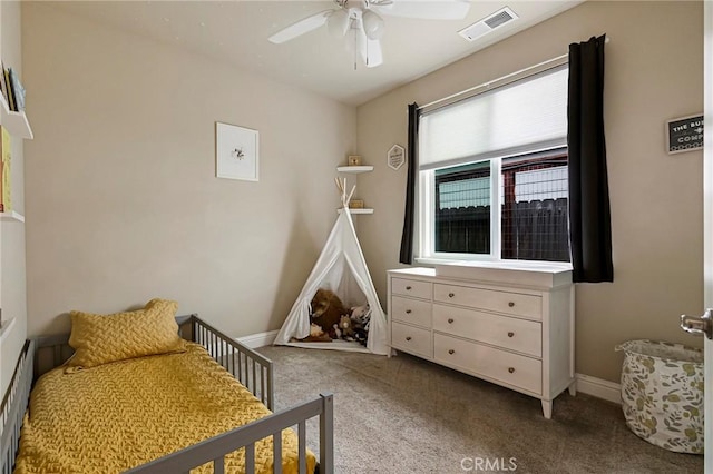 carpeted bedroom featuring visible vents, a ceiling fan, and baseboards